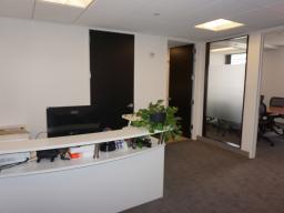 Reception area adjacent to conference room with frosted glass panel