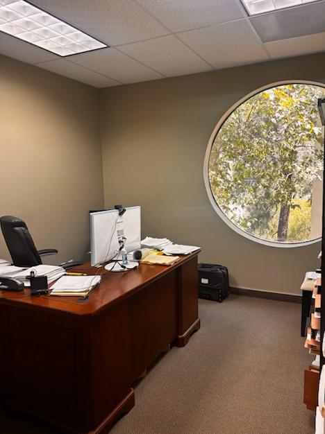 Desk in office with round window