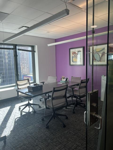 large office with glass wall, windows and table