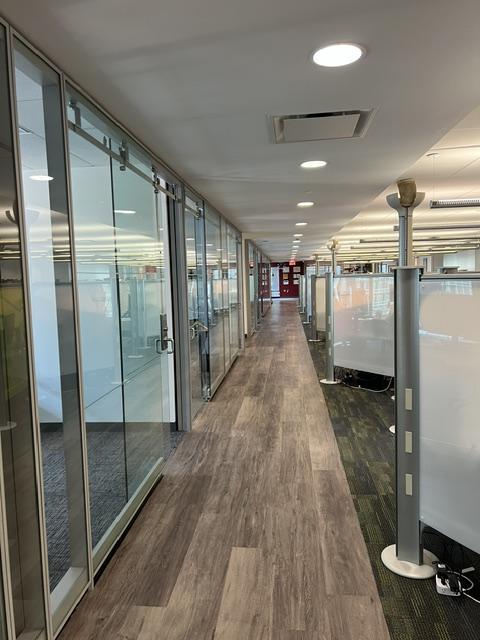 Row of glass wall office entrances from hall